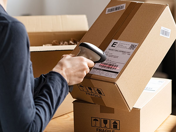 woman scanning a shipping label on a package